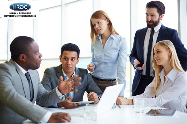 Team Of Five Colleagues Meeting For Discussion