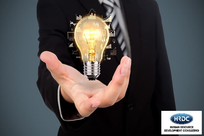 Business Man Holding Light Bulb